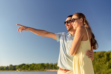 happy couple hugging on summer beach