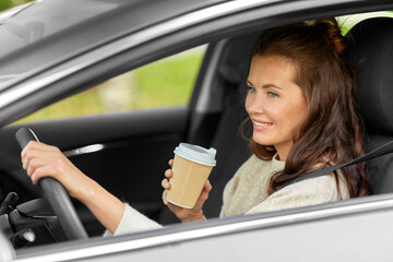 woman or female driver with coffee driving car