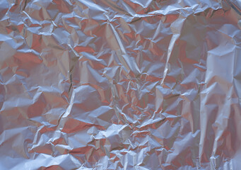 Crumpled foil background with silver color.