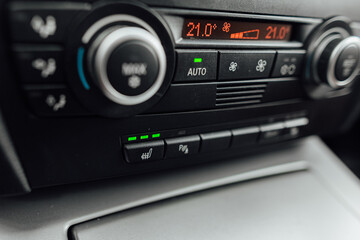the climate control panel in a car with bench heating on has a visible level of interior heat