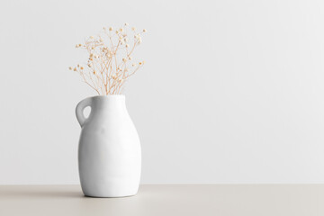 Dried gypsophila in a vase on the beige table with blank copy space.