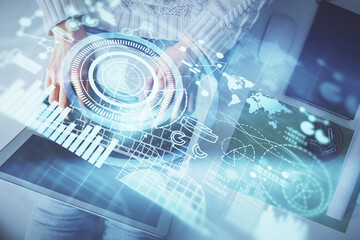 Double exposure of woman hands working on computer and financial theme hologram drawing. Top View....