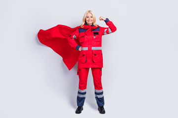 Full length photo of strong brave old woman work hero ambulance wear cape show muscle isolated on...