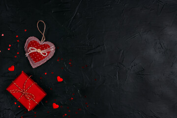 Red gifts with hearts on black background. Valentine's day concept.
