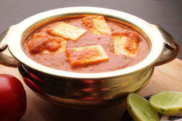 Paneer Butter Masala also known as Panir makhani or makhanwala. served in brass bowl 
