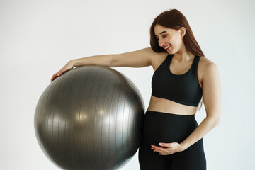 Pregnant woman doing sports in gym