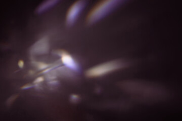 Blur colorful cold rainbow light leaks on black background with dust texture. Defocused abstract...