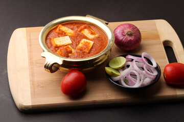 Paneer Butter Masala also known as Panir makhani or makhanwala. served in brass bowl 
