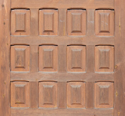 wooden plank with 12 carved rectangles. middle plan of an antique european style door.