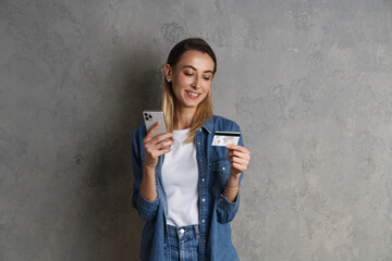 Portrait of a happy girl holding mobile phone