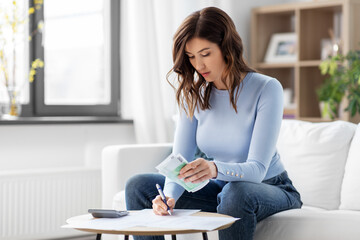 woman counting money at home