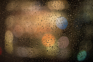 raindrops and night lights through the window 