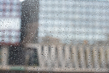 raindrops on the window and the city through the glass