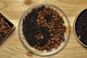 Coffee beans and black tea leaves, laid out in the yin-yang symbol