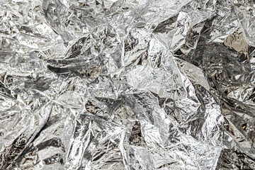 Background of crumpled silver foil. Flat lay. Copy space