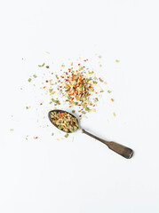 Dry seasoning of various vegetables and herbs in a vintage spoon