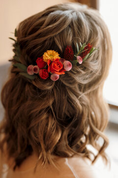 bridesmaid hairstyle in the back with red flowers in her hair