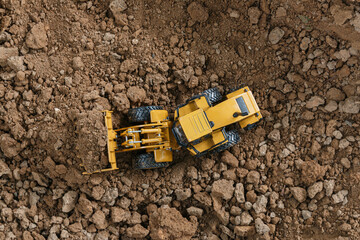 Wheel loader are digging the soil in the construction site ,Top view