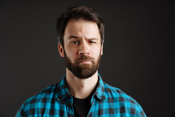 Bearded puzzled white man frowning and looking at camera