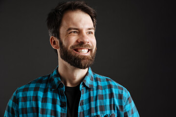Obraz premium Bearded happy white man smiling and looking aside