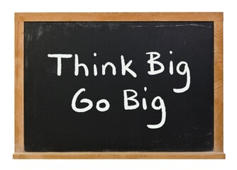 Obraz premium Think Big Go Big written in white chalk on a black chalkboard isolated on white