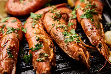 Grilled large shrimps with lemon and spices on the grill pan