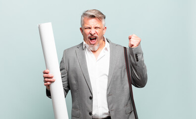 senior architect shouting aggressively with an angry expression or with fists clenched celebrating...