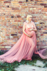 Fototapeta premium Pregnancy woman in a pink dress