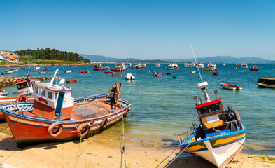 Colorful beach scene in picturesque Arousa island in the Galicia region of Spain, with traditional...