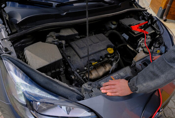 Mechanic hands on open hood. Open hood at service station close-up. Car open bonnet top view