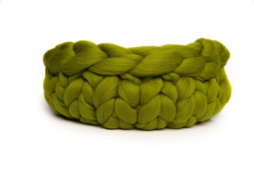 Obraz premium Green woolen animal bed or basket isolated on a white background