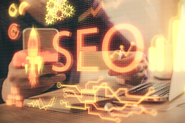 Multi exposure of man's hands holding and using a digital device and seo drawing. search...