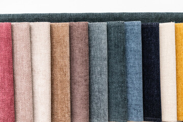 A set of tissue samples with different textures and colors. Multicolored fabric stripes in the...