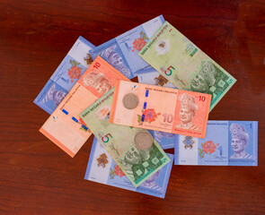 Malaysian ringgit and sen scattered on a wooden table