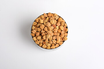 Dried chickpeas in bowl isolated on white background.