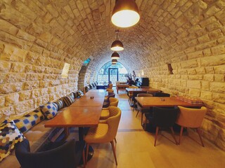 Beautiful restaurant interior with warm colors. Best architecture theme. Winter season. Colorful chairs and tables. Romantic and peaceful dining area. Restaurant and guest house in Lebanon. Travel