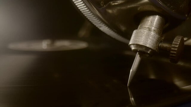 The needle of an old gramophone is placed on a vinyl record. Macro Close up