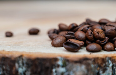 Coffee beans on wooden background, close up.