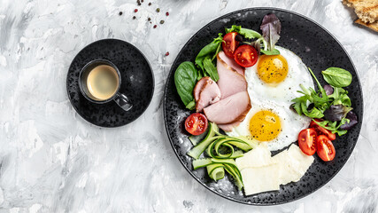 Fried eggs with ham and salad. Delicious English Breakfast. Delicious breakfast or snack on a light background, top view