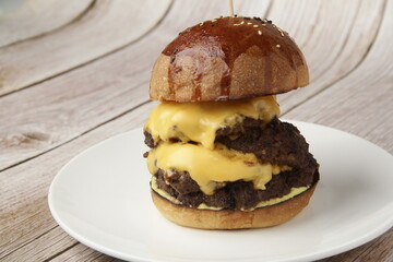 Freshly made giant hamburger sandwich with cheese and vegetables