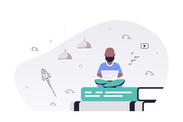 Man with laptop sitting on book stack