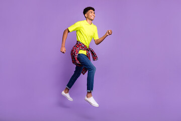 Full length profile side photo of young black guy happy smile jump go walk run hurry sale isolated over violet color background