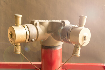 Red emergency water hydrant pipe fire equipment protection on street.