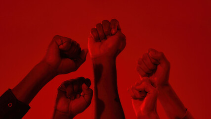 Fists on raised hands of multiracial people