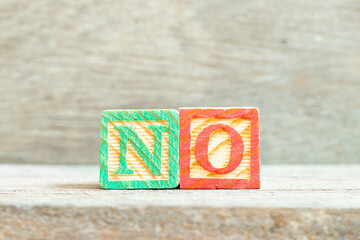 Color alphabet letter block in word no on wood background