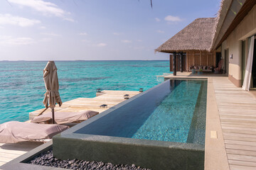 Luxurious exterior of a very expensive rich water villa in the Maldives, decorated with natural...