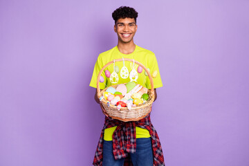 Photo of young handsome attractive happy cheerful smiling afro man hold easter basket isolated on...