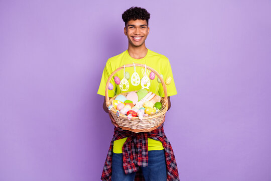 Photo of young handsome attractive happy cheerful smiling afro man hold easter basket isolated on violet color background