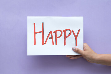 Woman's hand holding a sign