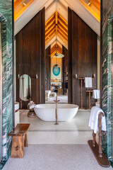 Luxurious interior of a very expensive rich water villa in the Maldives, decorated with natural wood.
